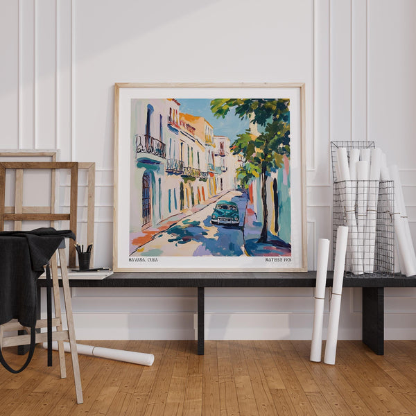 Paintings of Cuba showing old Havana street with lush tree cover.