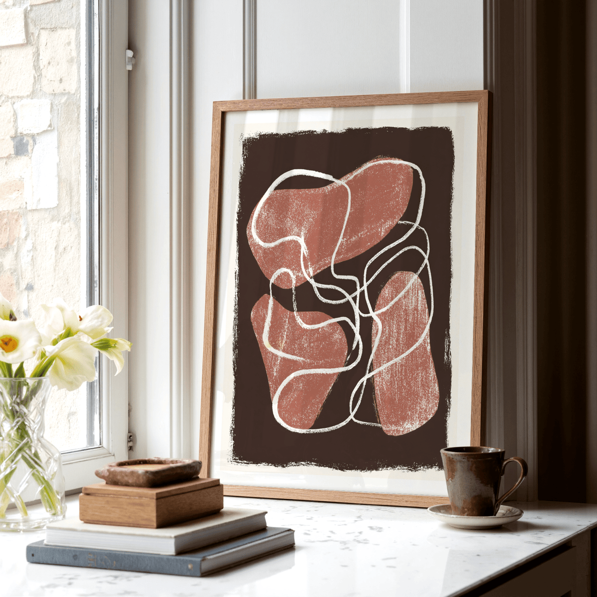 Textured abstract wall art print with rounded red forms and scribbled white linework on a brown rectangle