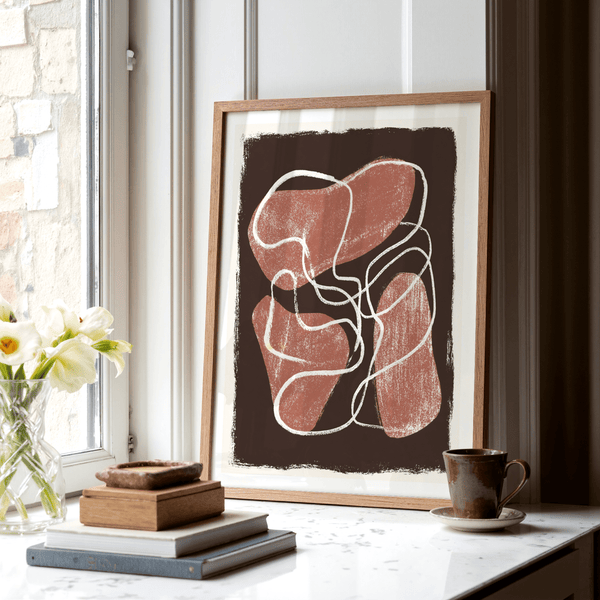 Textured abstract wall art print with rounded red forms and scribbled white linework on a brown rectangle