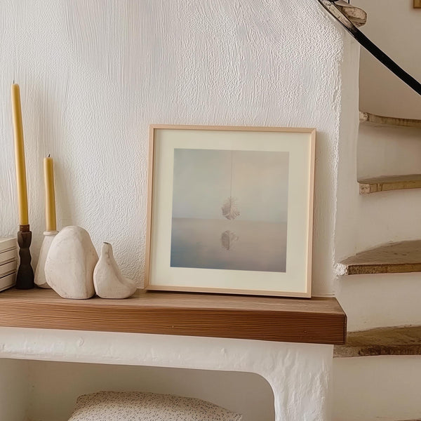 Minimalist surrealist wall art featuring an elegant feather composition