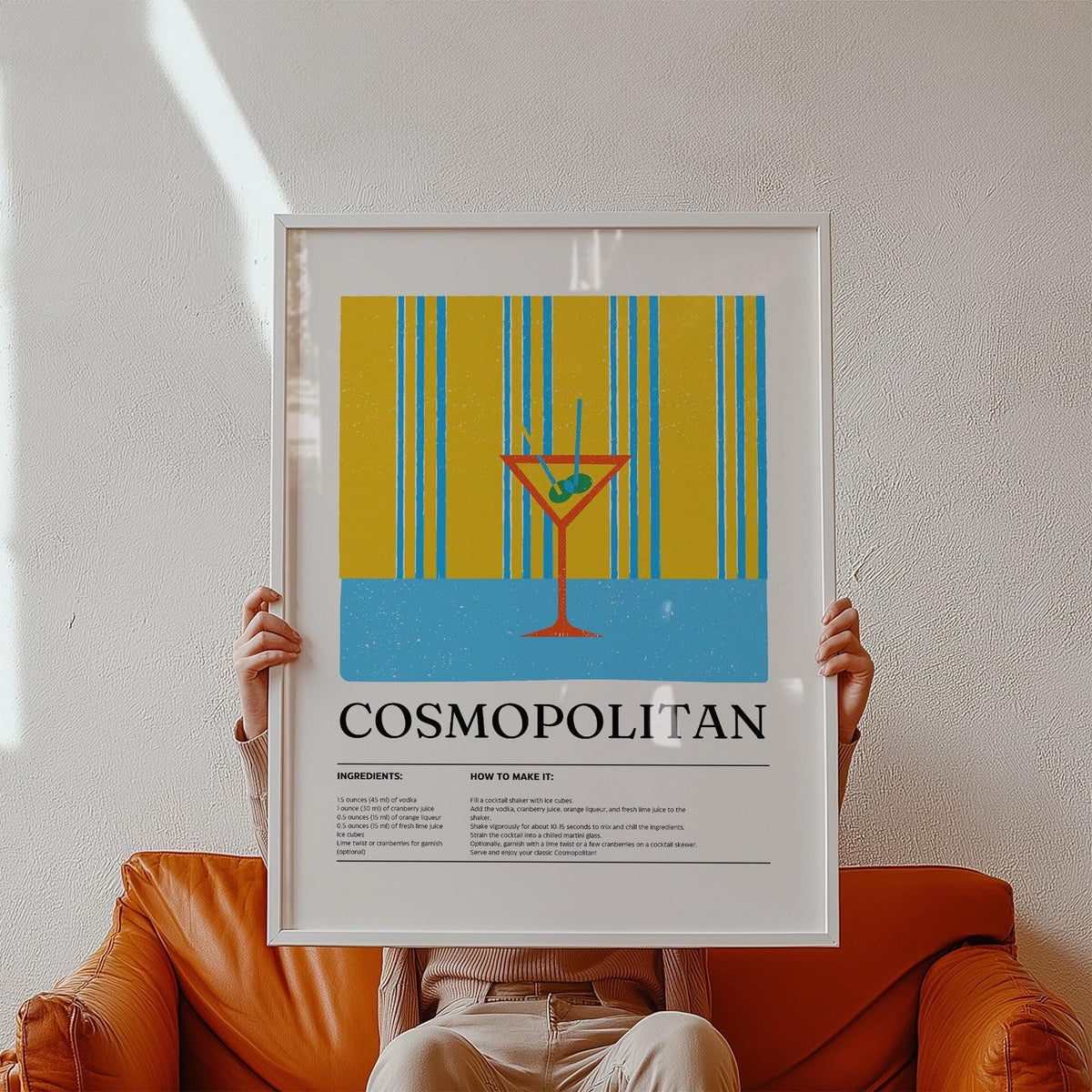 Art Prints for the Kitchen framed print of colourful minimalist cosmopolitan cocktail illustration held against a white wall