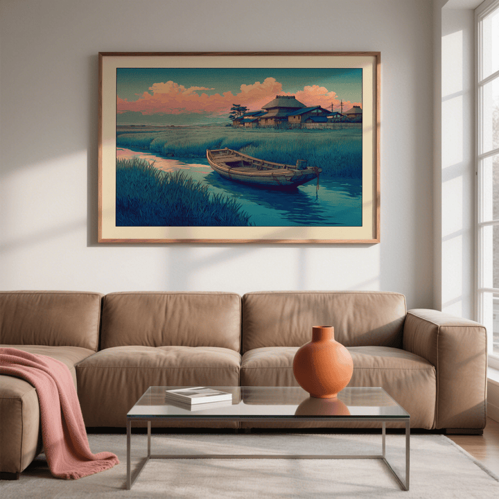 Hasui Kawase River Boat print on a wall with wooden frame above tan sofa and glass coffee table with orange vase