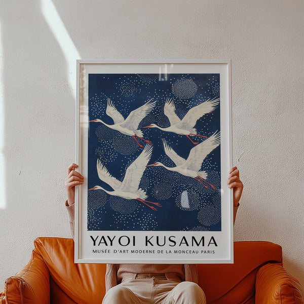 Blue and White Prints with four cranes gliding through a starry sky of dots.