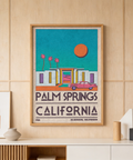 Framed view of retro Palm Springs poster showing a modern building and parked vintage car