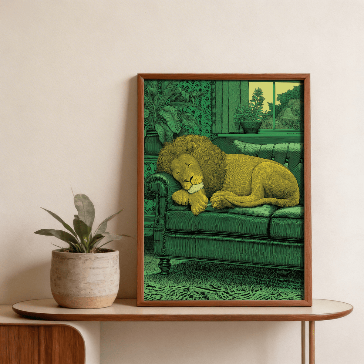 Framed sleeping lion print in green and yellow tones beside a potted plant on a wooden console