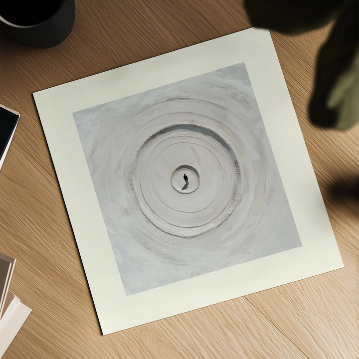 Surrealism Posters close-up of concentric sand circles in muted greys and beiges on a wooden surface with cup nearby