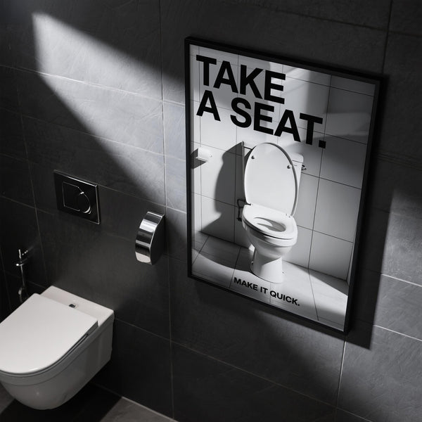 White ceramic toilet in direct light with funny bathroom art message.
