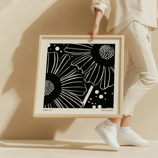 Modern black and white floral wall art featuring bold line work and dots