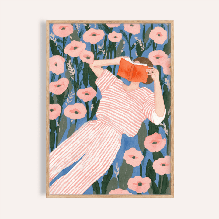 Reclining woman reading poster with open book among large flowers