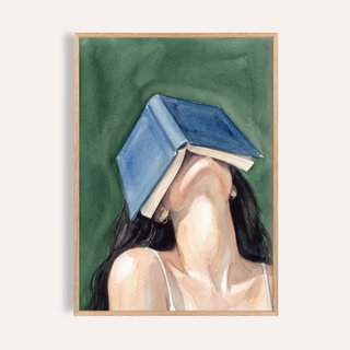 Angled view of Woman Reading Portrait Print watercolor poster with a book covering a faceless woman