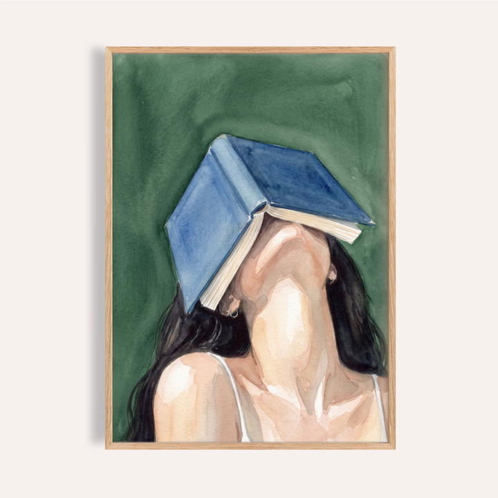 Angled view of Woman Reading Portrait Print watercolor poster with a book covering a faceless woman