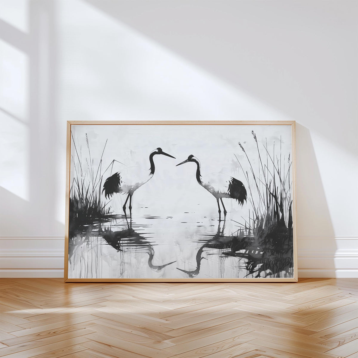 Minimalist bird print featuring two cranes in black and white with water reflections.