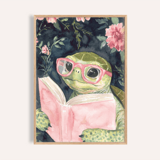 Framed Turtle Reading Art Print of a turtle with pink glasses holding a pink book