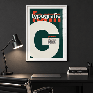 Cream letter G on forest green print in a home office against a charcoal wall