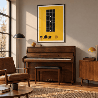 Black fretboard on mustard yellow print above a piano in a living room