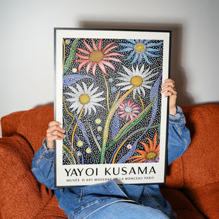 Abstract botanical wall art showing vibrant orange, pink, and blue flowers with white dots.
