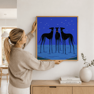 Modern Dog Wall Art hung above a sofa in a blue toned living room
