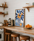 Orange blue wall art print laid flat on white table with art supplies.