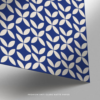 A poster of blue modern wall art laid flat next to a kraft paper tube for scale.