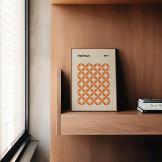 Modern interior with framed orange minimalist print hanging above console table.