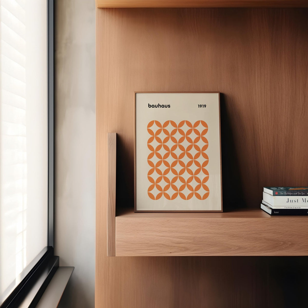 Modern interior with framed orange minimalist print hanging above console table.