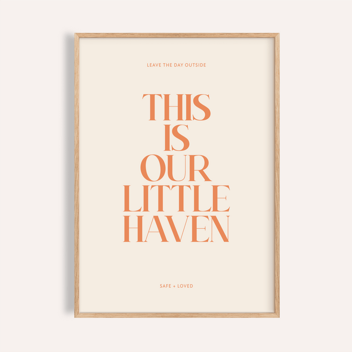 Centered quote wall art poster reading “This Is Our Little Haven” in orange serif type on beige