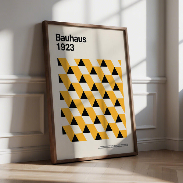 Bauhaus Poster 1923 featuring yellow and black geometric triangles on cream background.