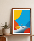 Dominating the sky area, Cycling Art Print wall art shows a small cyclist below large geometric color fields