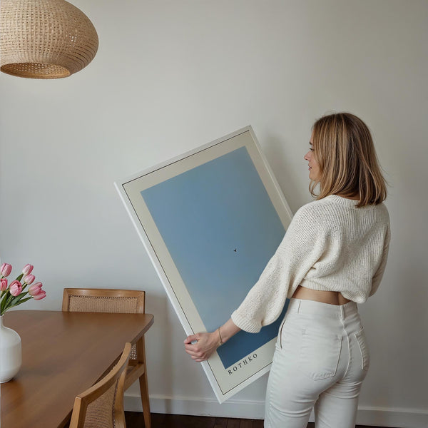 Rothko-style blue wall art with horizon and flying bird silhouette.