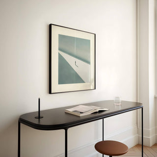 Large modern art print featuring a solitary figure and vast background.