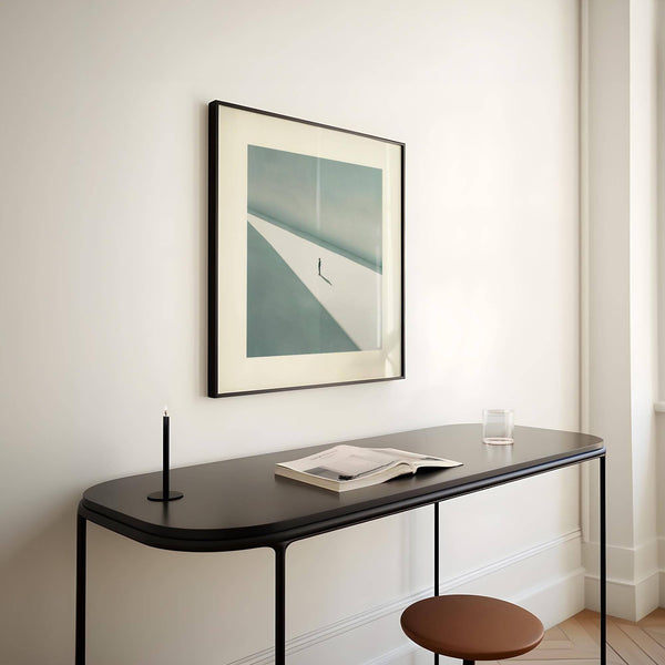 Large modern art print featuring a solitary figure and vast background.