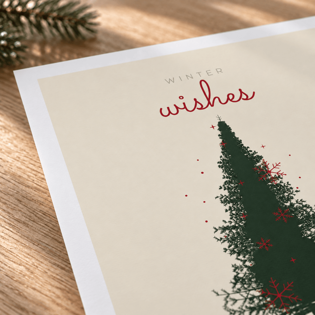 Close view of the cream and green Christmas tree print showing the paper texture and lettering