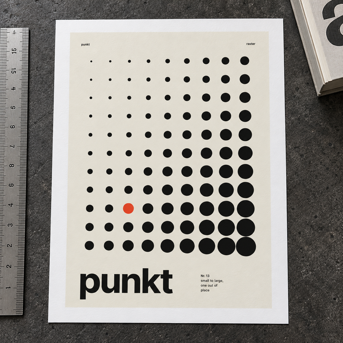 Close view of the Swiss style dot print with one red dot on smooth matte paper