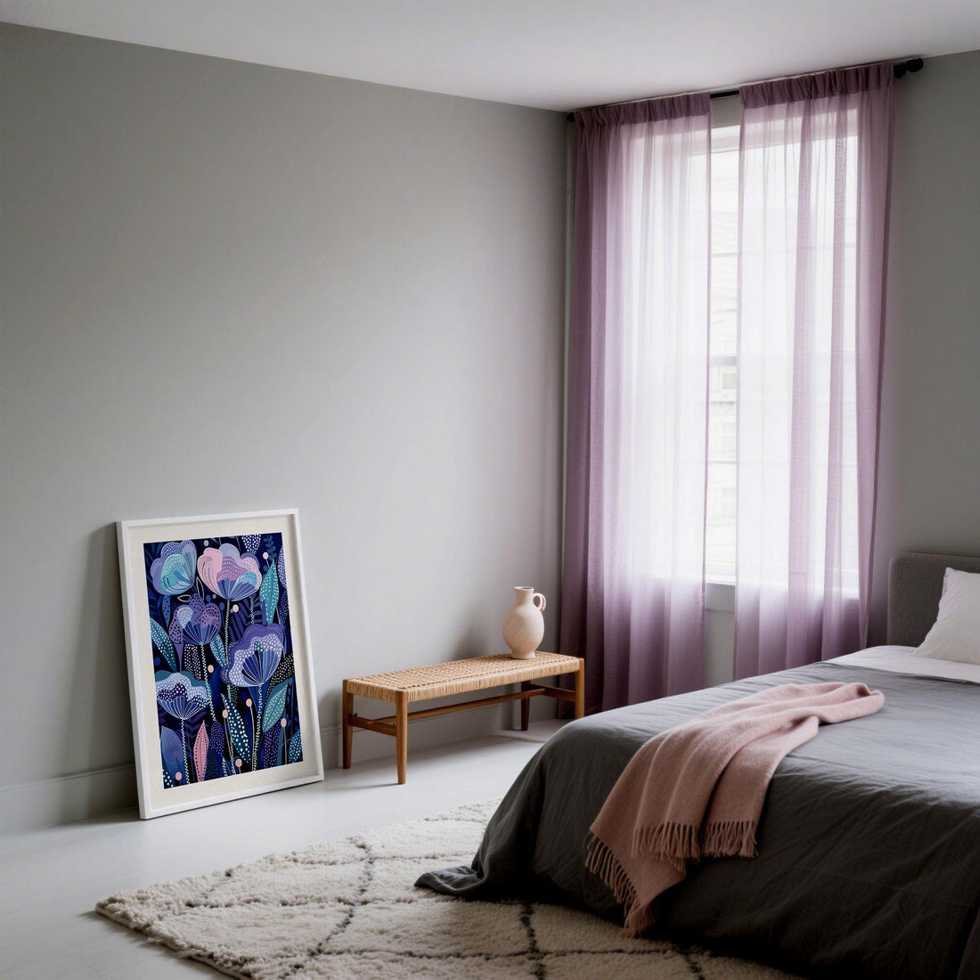 Bedroom with lilac curtains, grey bedding and a blush throw, with a purple flower print leaning against the wall