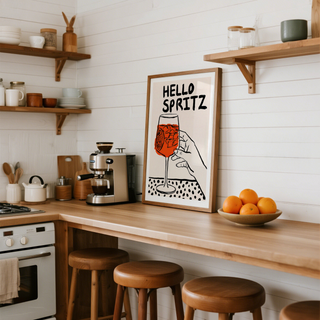 Graphic drink wall art showing orange spritz in stemmed glass with citrus slice and bold text