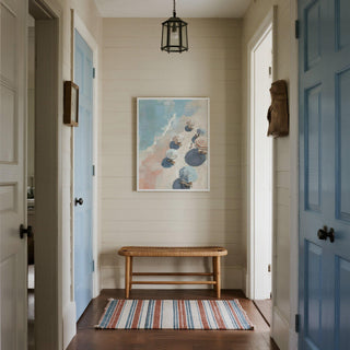 Minimalist beach umbrella print with loungers on a pale sandy shore.