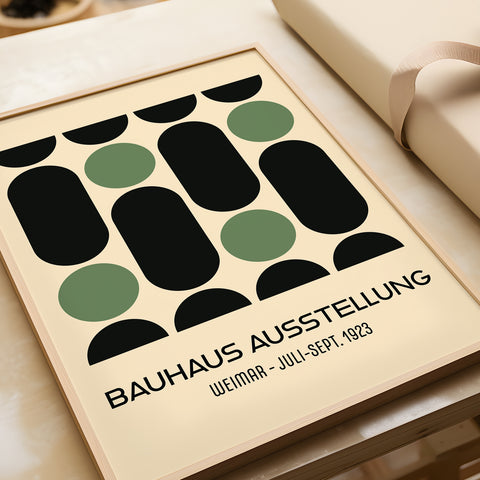 Green and black Bauhaus poster displayed in a room