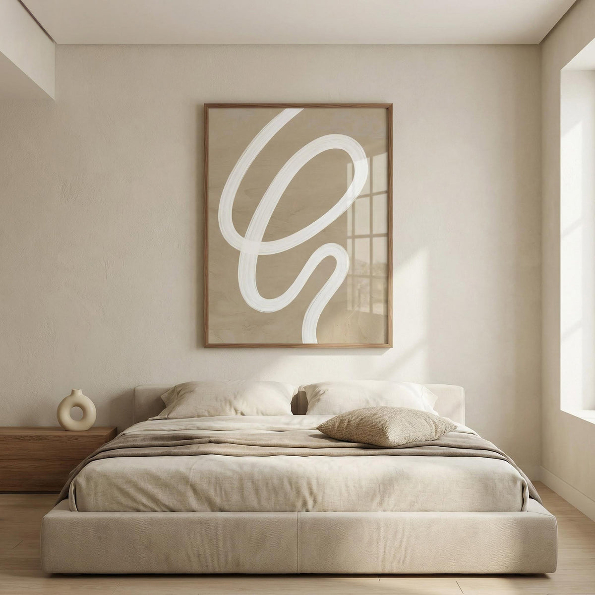 Modern bedroom with a bed, nightstand, and abstract wall art.