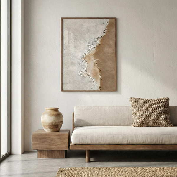 Modern living room with a beige sofa, wooden side table, and abstract art on the wall.