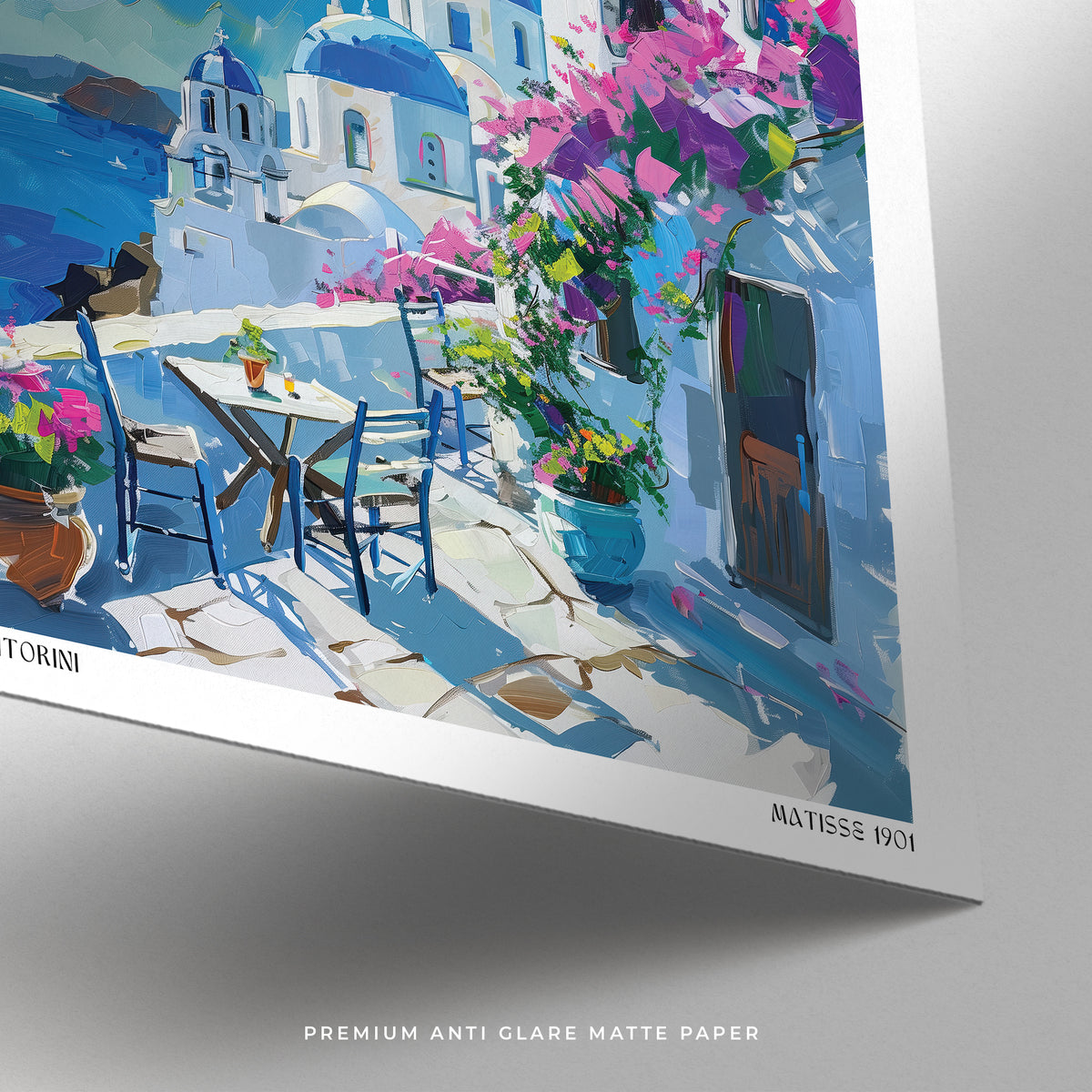 Colorful painting of a Mediterranean Santorini scene with a table, chairs, and flowers.