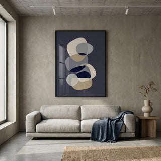 Modern living room with a gray sofa, abstract art on the wall, and a vase on a side table.