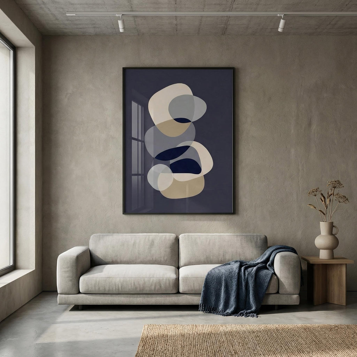 Modern living room with a gray sofa, abstract art on the wall, and a vase on a side table.