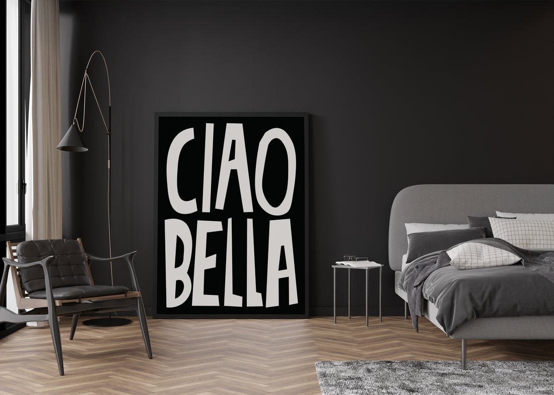 Large black and white CIAO BELLA typography poster leaning against a dark grey bedroom wall