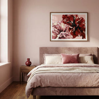 Bedroom with floral artwork on the wall and a bed with pink bedding.