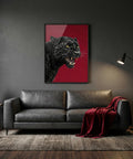 Living room with a gray sofa, red blanket, and a framed picture of a black panther on a red background.