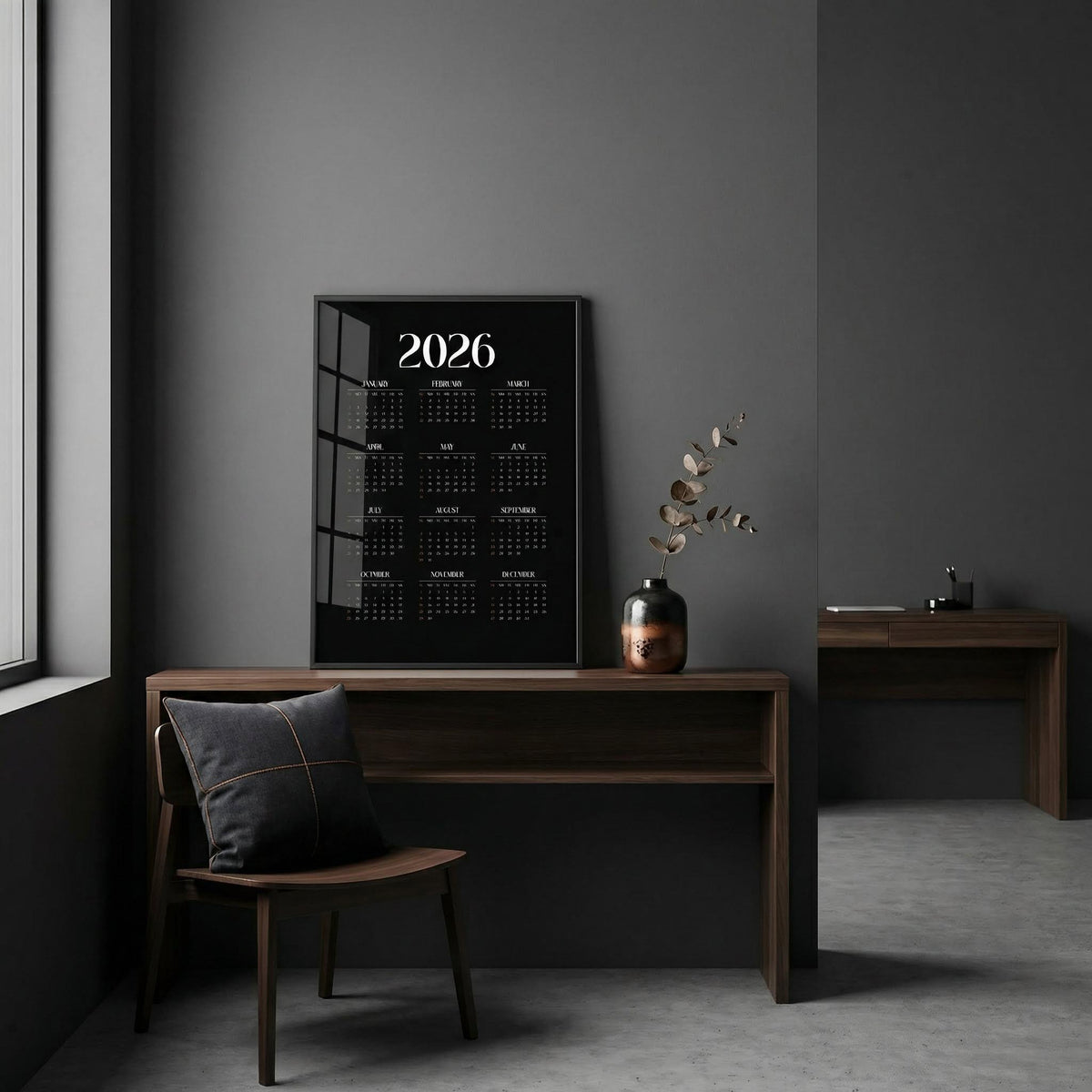 Calendar for 2026 on a wall in a minimalistic room with a desk and chair.