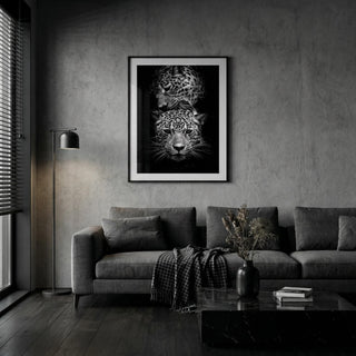 Living room with a gray sofa, coffee table, and wall art of a leopard's face.