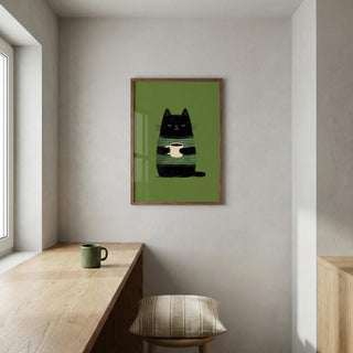 Framed artwork of a black cat on a green background in a minimalistic room.
