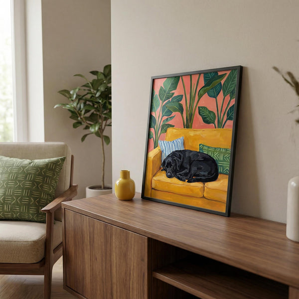 Framed artwork of a black dog on a yellow couch in a living room setting.