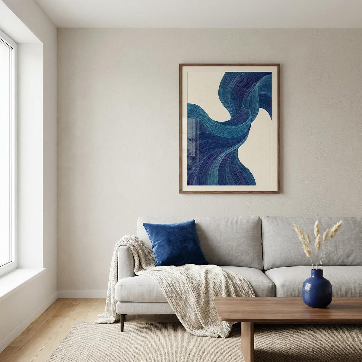 Living room with a gray sofa, blue pillow, and abstract art on the wall.